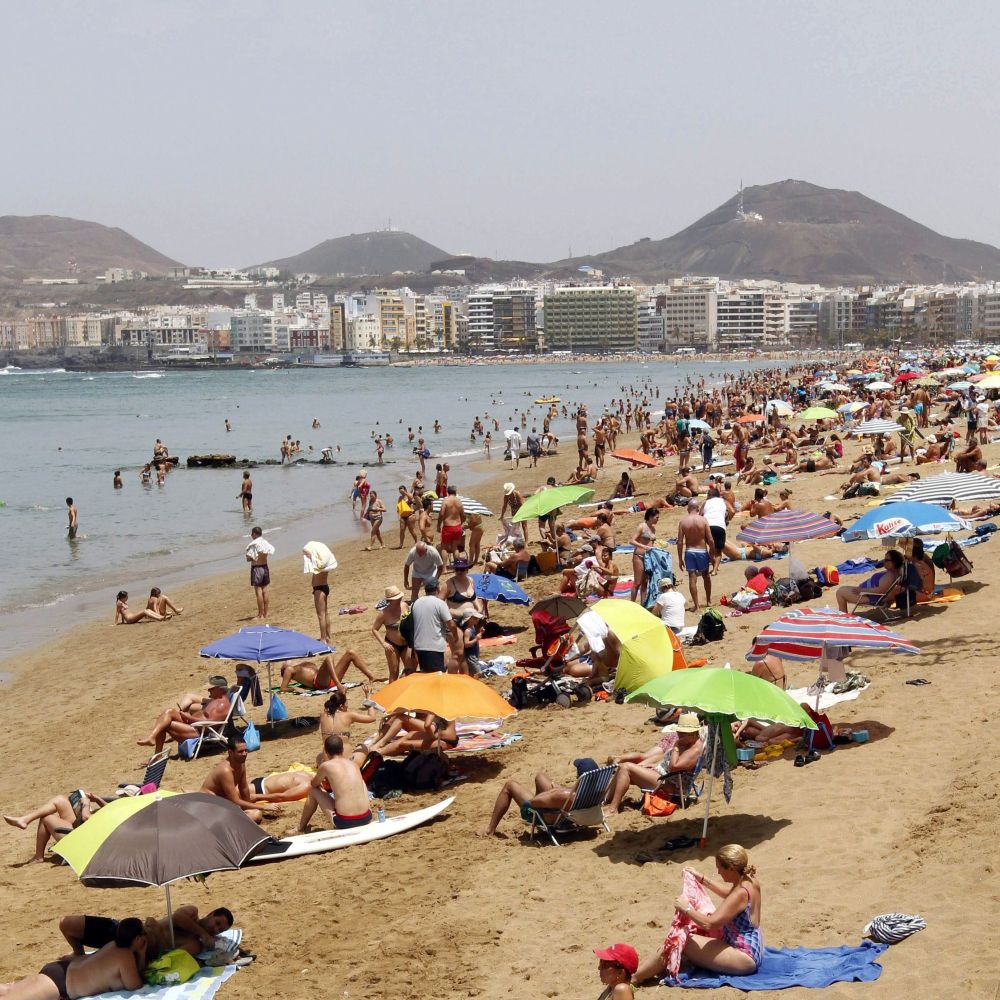 Туристи на плаж в Испания
