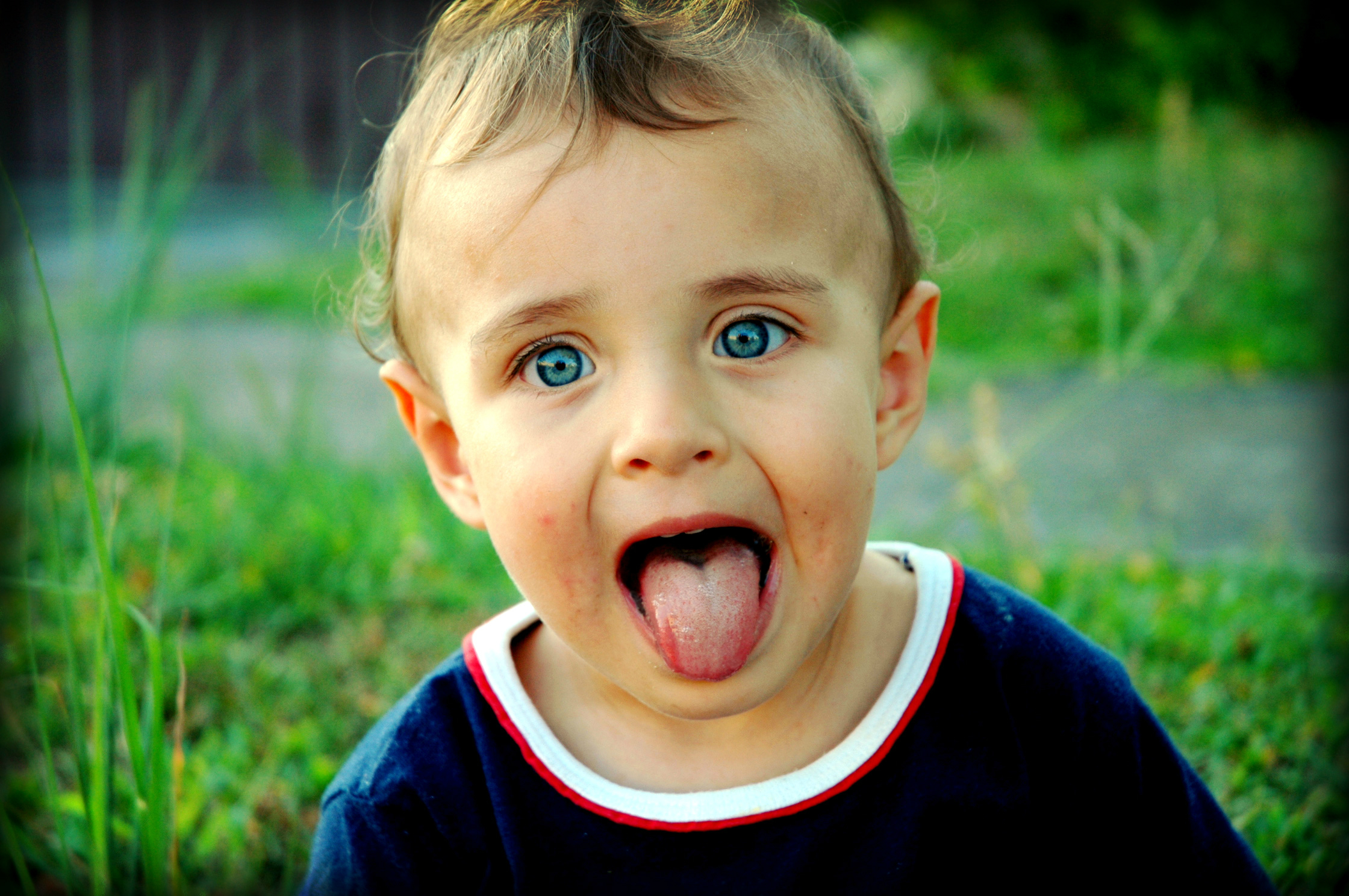 Звук показывает язык. Высунутый язык. Ребенок показывает язык. Мальчик высунул язык.