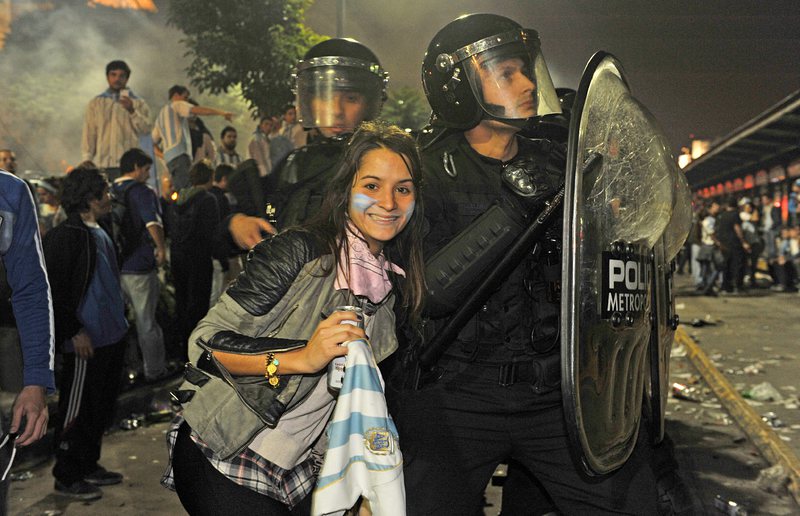 Футболна фенка се снима с полицаите по време на размириците