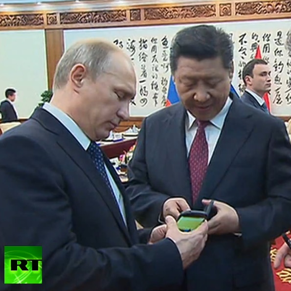 Владимир Путин и Си Цзинпин разглеждат руския смартфон