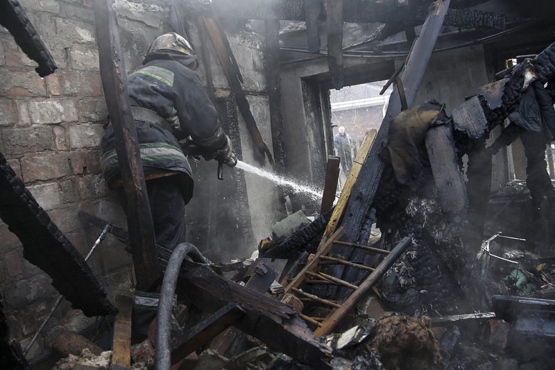 Пожарникари разчистват изгоряла след обстрел сграда в Донецк
