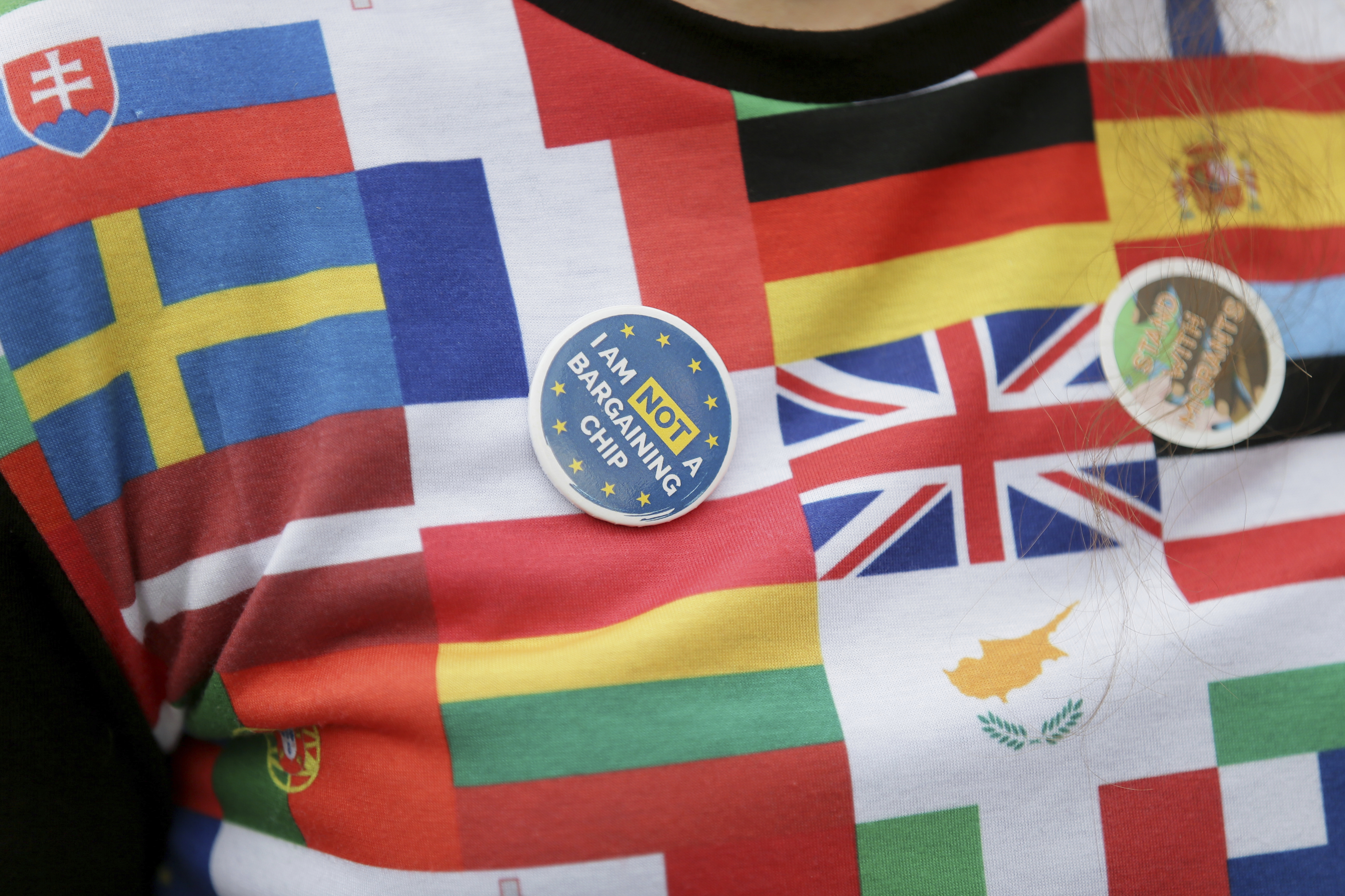 Демонстрант пред британския парламент носи тениска с изобразени флаговете  на страни от ЕС