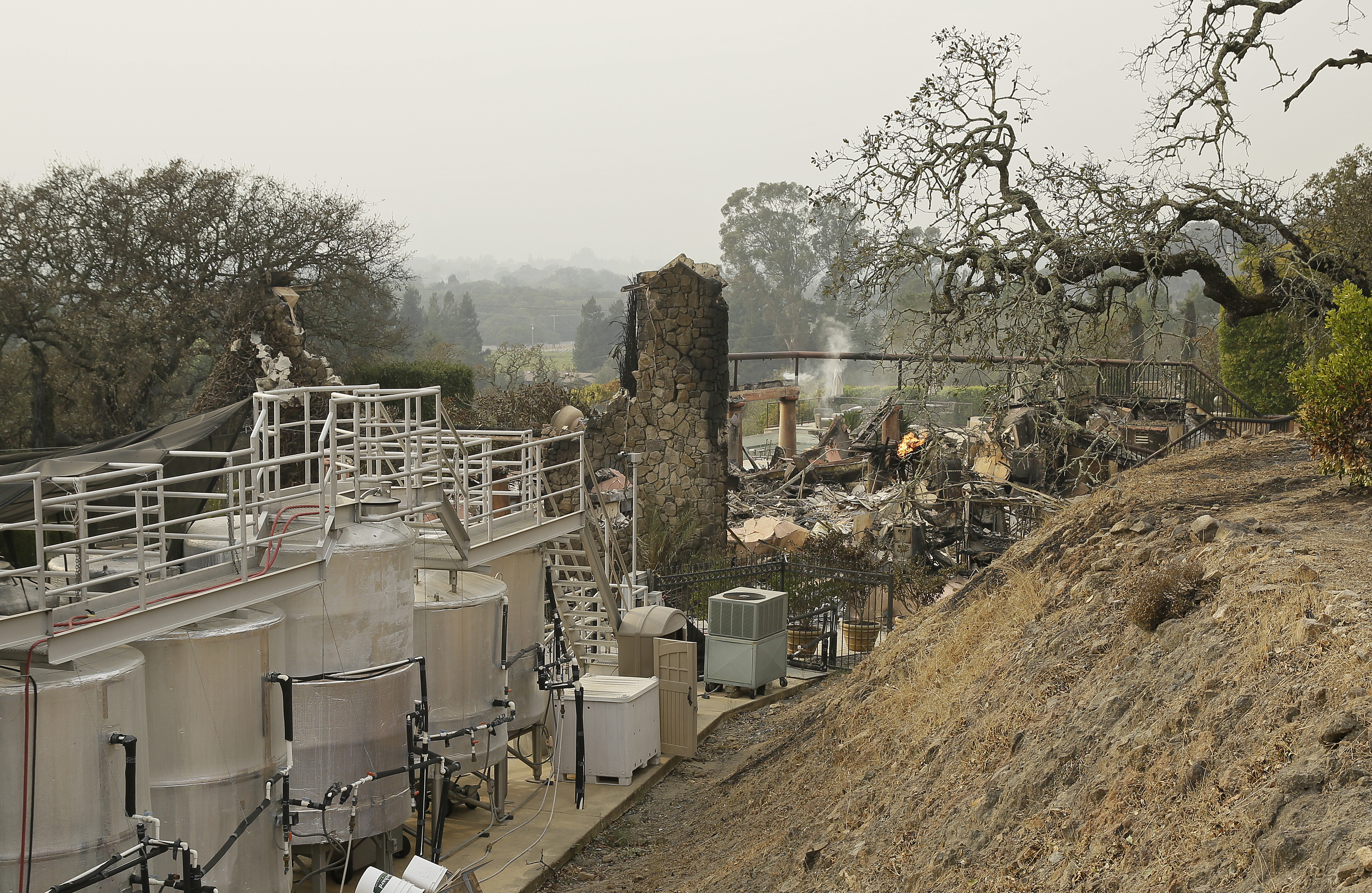Ферментационни съоръжения на винарна в Напа, Калифорния, до останки от пожарите