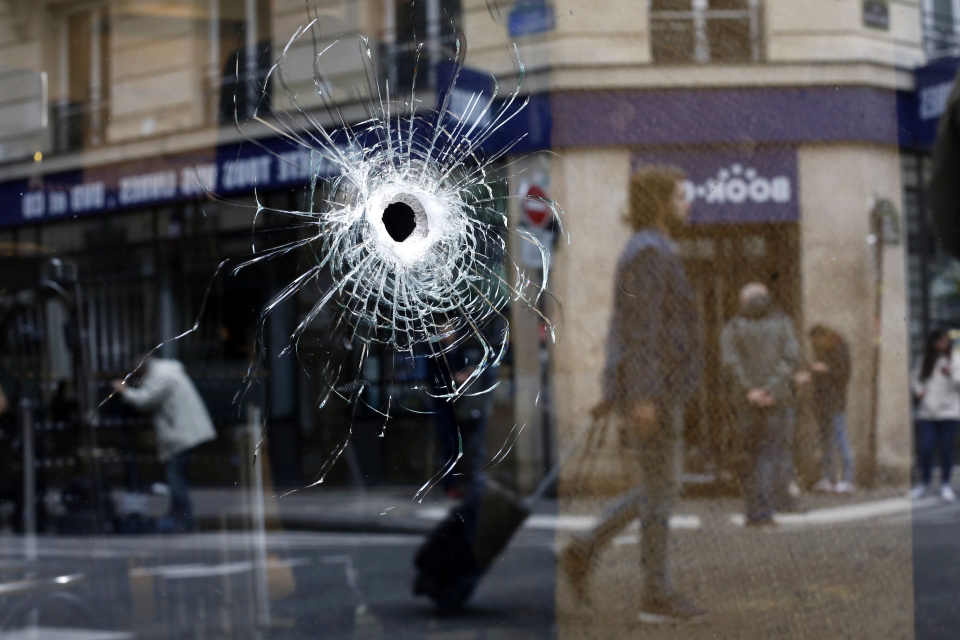 Дупка на куршум на прозореца на кафене в района, където нападателят на нападателна атака беше застрелян нападателят с нож