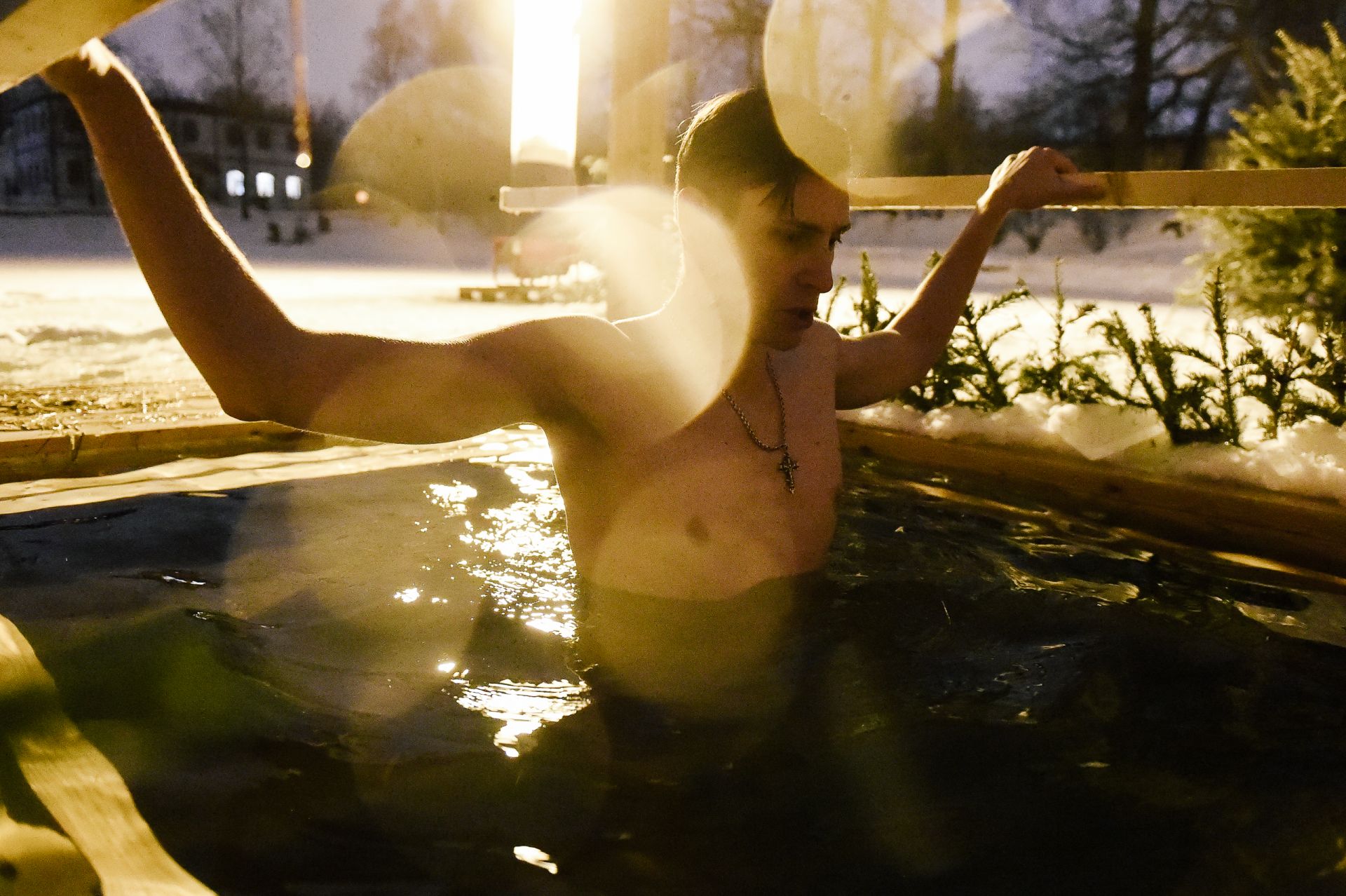 Мъж се потапя в ледената вода по време на празненствата на православното Богоявление в Москва
