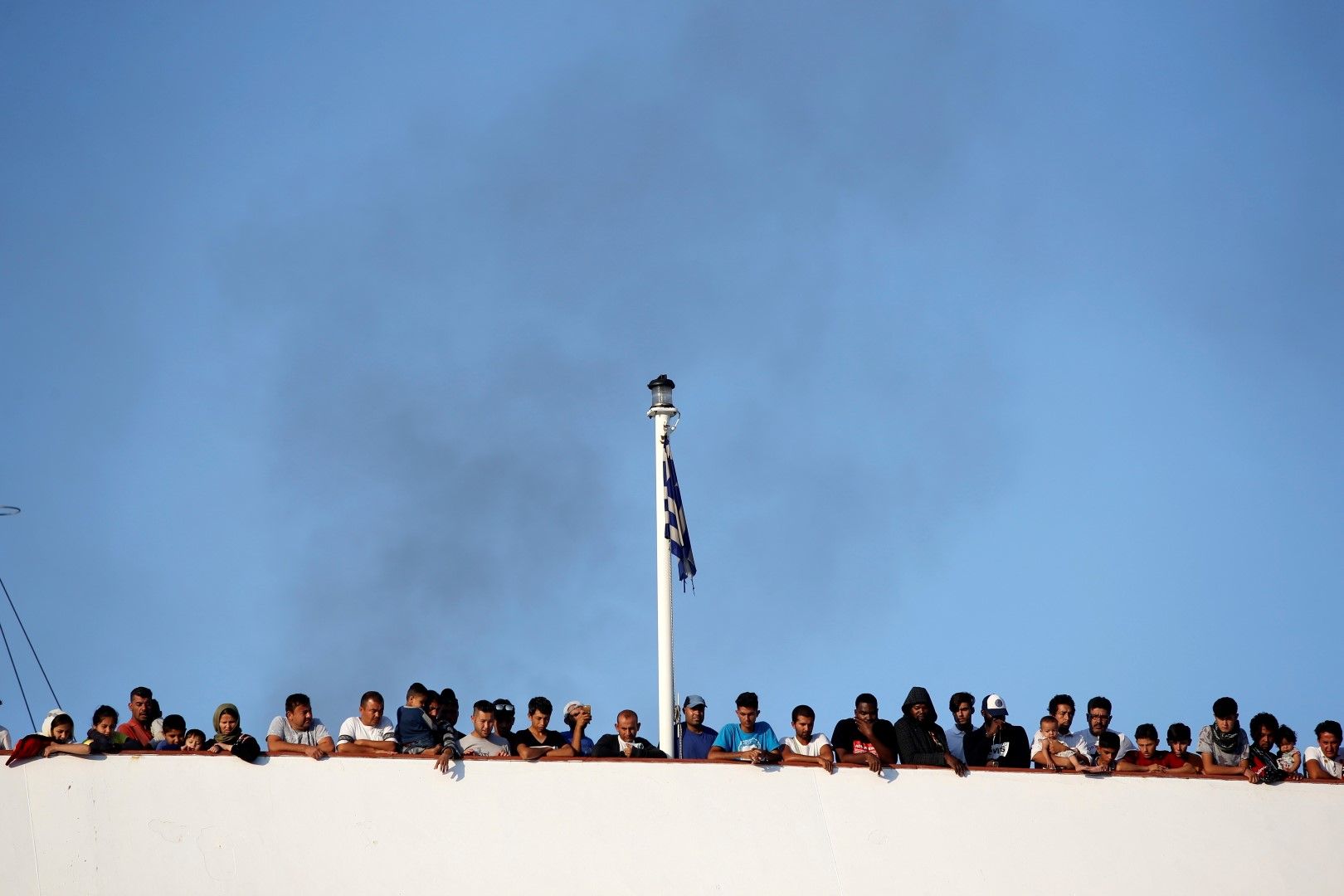 Мигранти на ферибота, който пристига на пристанището в Солун от остров Лесбос