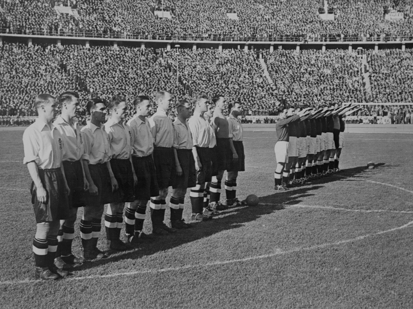 Английският отбор по време на химна на Великобритания преди мача. Немските футболисти го "уважават" с нацисткия поздрав