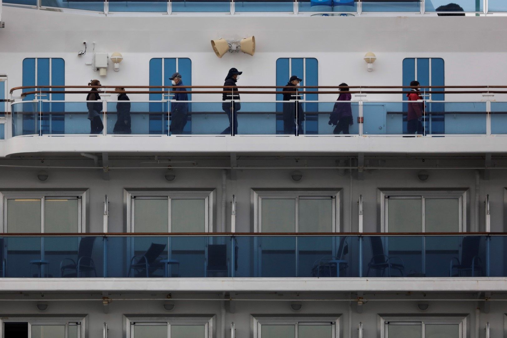 Пасажери се разхождат на палубите на круизния кораб Диамантената принцеса, поставен под карантина на японско пристанище