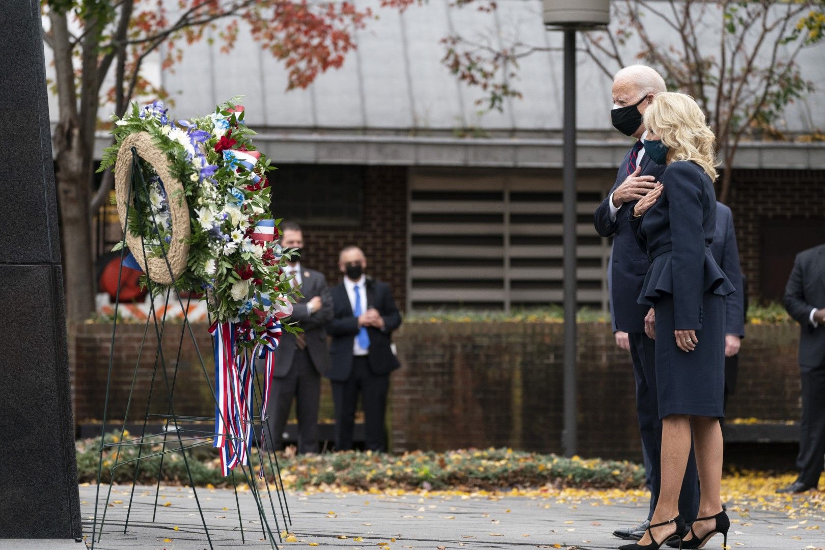 Джо Байдън и Джил Байдън стоят с ръце над сърцaта си, след като са пложили венец на паметника на жертвите от Корейската война във Филаделфия, в Деня на ветераните, 11 ноември