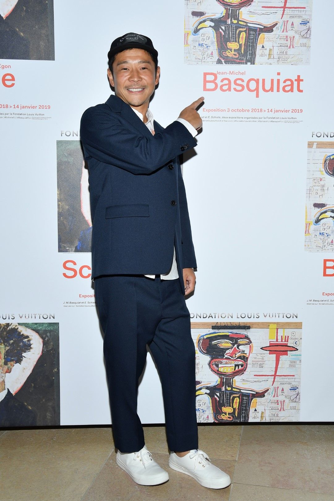 Юсаку Маедзава отказва да посочи точна цена за пътуването, но казва, че е повече от 110-те милиона долара, която плати за картина на Жан-Мишел Баския. Снимката е от 1 октомври 2018 г. по време на изложба на Баския, която японецът посети