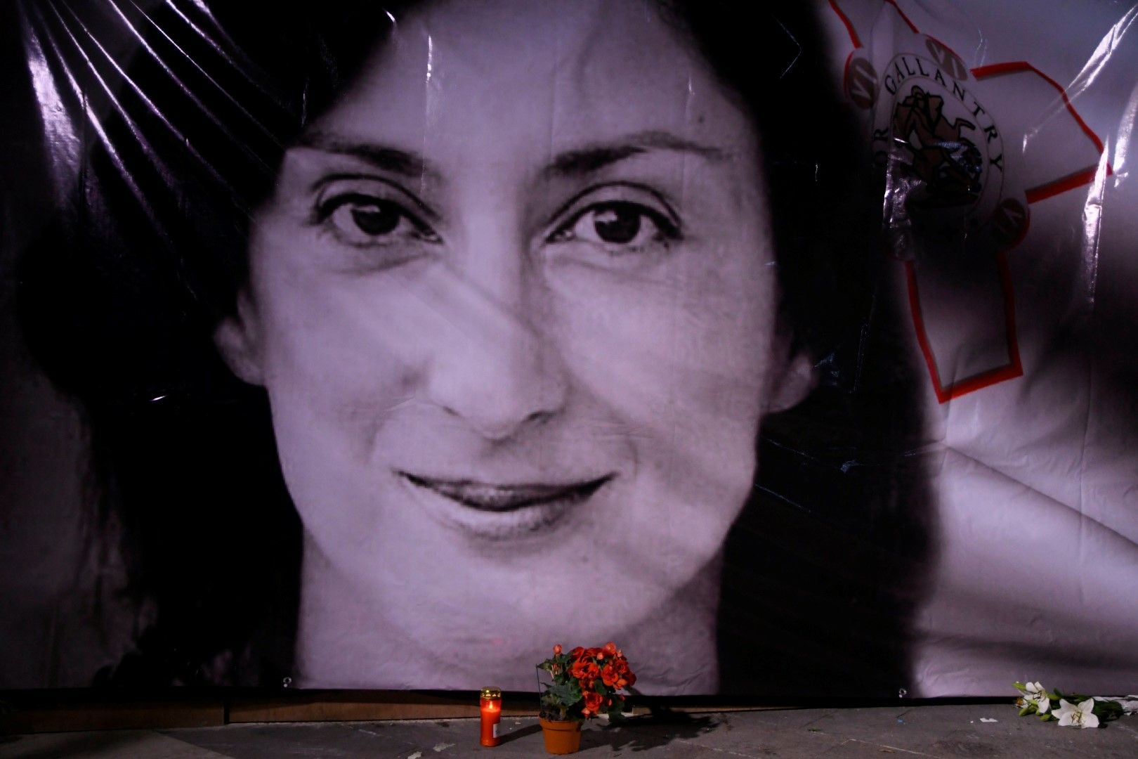 Цвтя и свещи пред портрет на убитата разследваща журналистка Дафне Каруана Галиция по време на бдение пред съдебните зали във Валета, Малта, 16 октомври 2018 г.