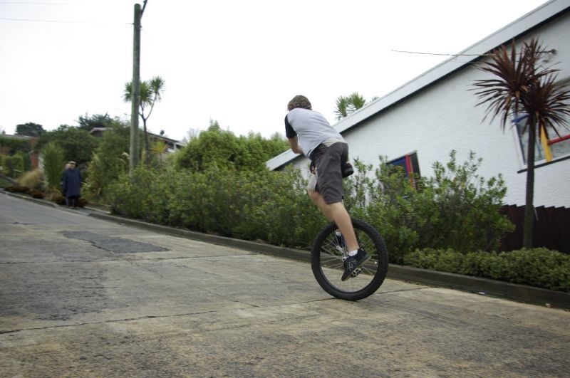 За да се изкачи по улицата, този младеж трябва да се наклони напред, за да запази равновесие
