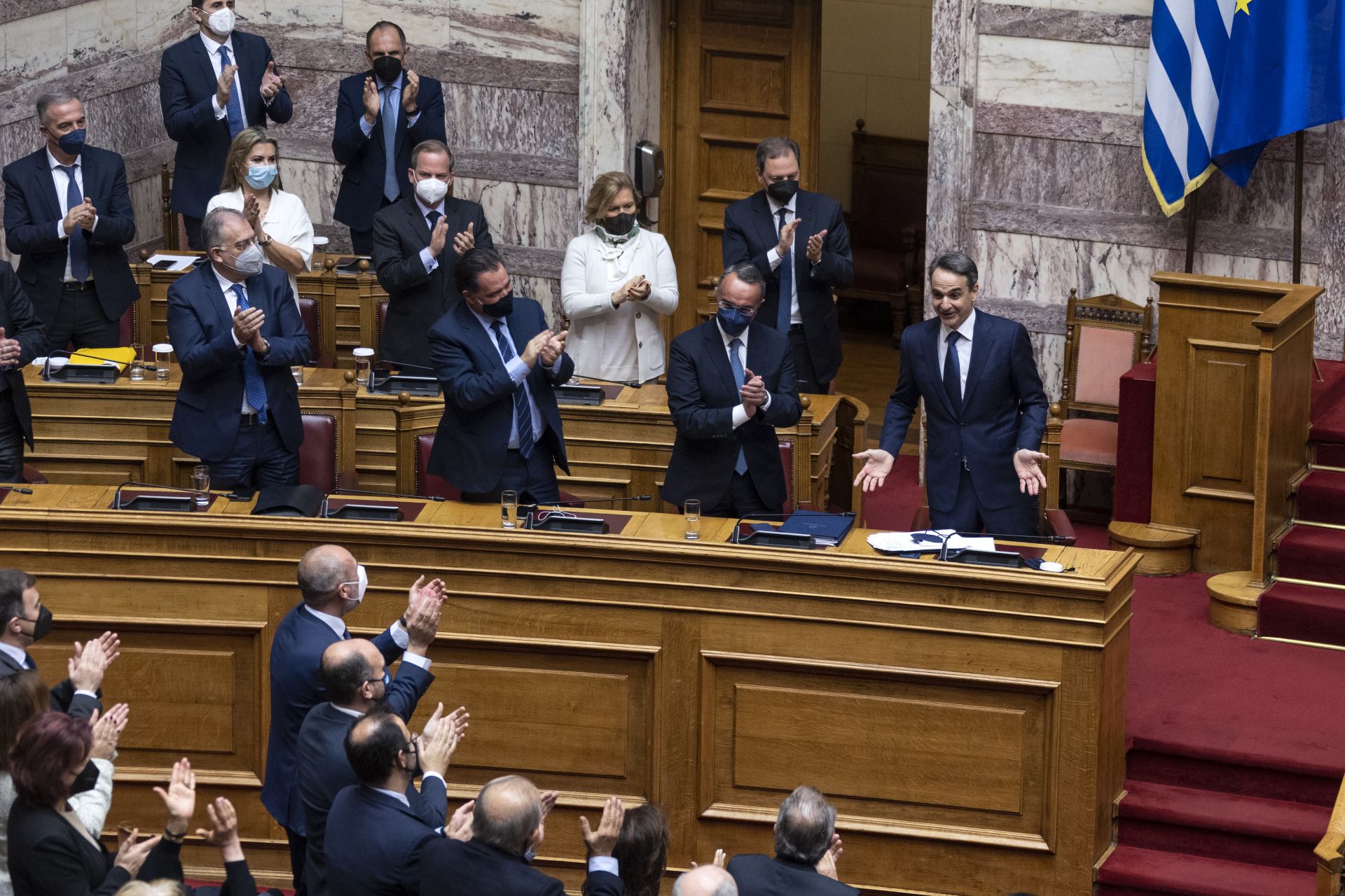 Гръцкият премиер Кириакос Мицотакис е аплодиран от депутатите на своята партия по време на сесия на парламента в Атина, неделя, 30 януари 2022 г.