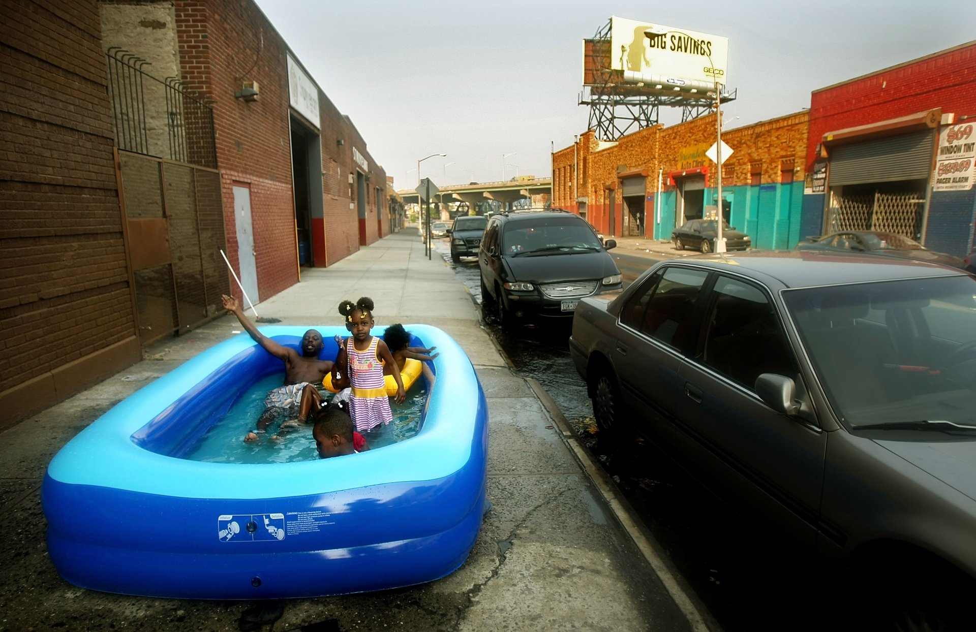 НЮ ЙОРК - 10 ЮНИ: Жителите на Ню Йорк се разхлаждат в надуваем басейн на тротоара на 10 юни 2008 г. в квартал Бронкс в Ню Йорк. Температурите отново достигнаха до 90 градуса по Фаренхайт по време на ранната гореща вълна в града. 