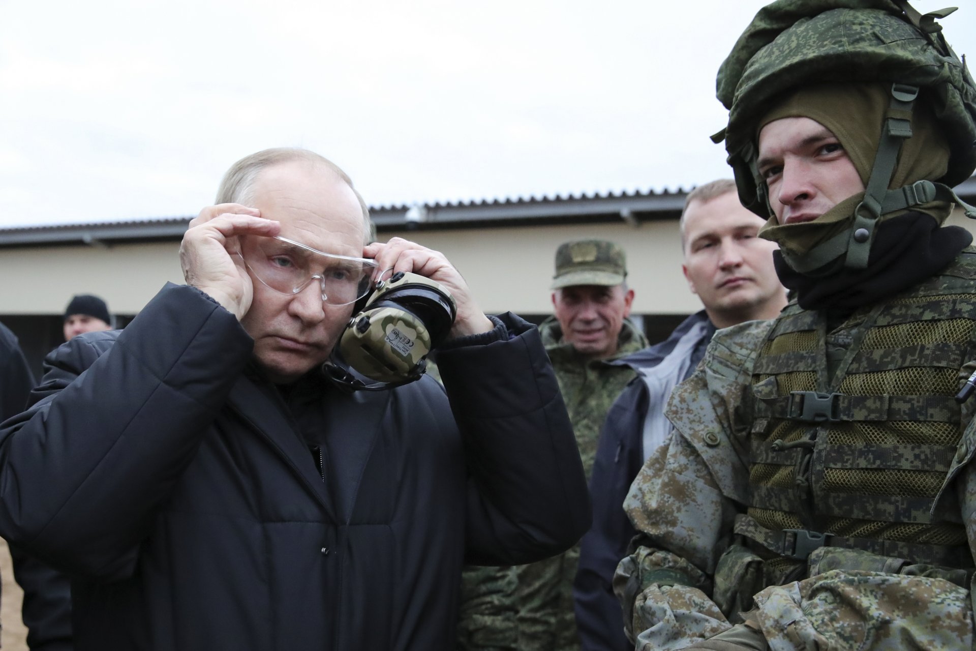 Руският президент Владимир Путин слага защитни очила, докато е на посещение в учебен център на Западния военен окръг за мобилизирани резервисти в Рязанска област, Русия, четвъртък, 20 октомври 2022 г.
