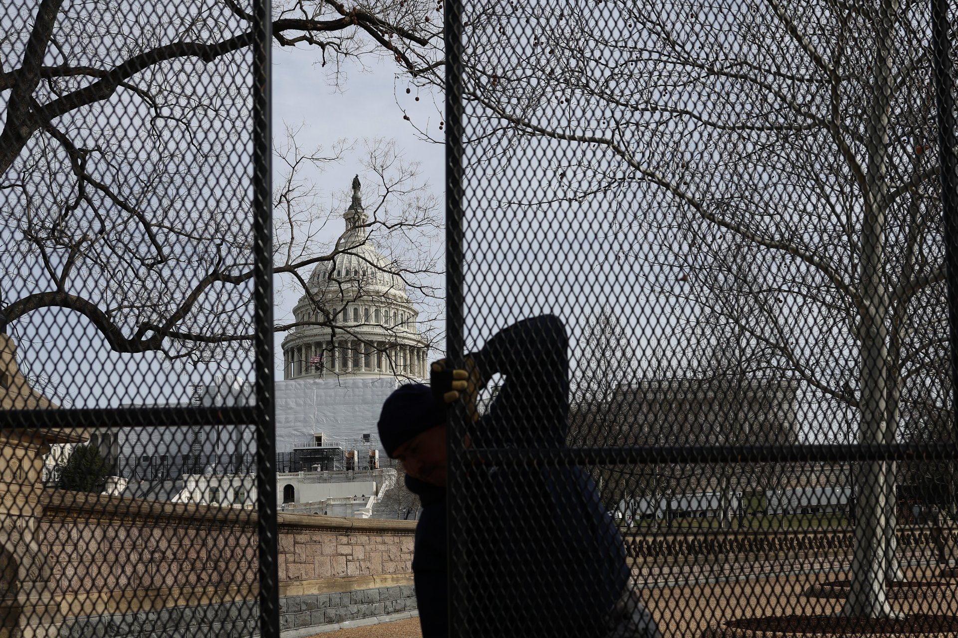Работник инсталира защитна ограда около Капитолия. Тя бе монтирана като част от засилени мерки за сигурност преди речта на президента Джо Байдън