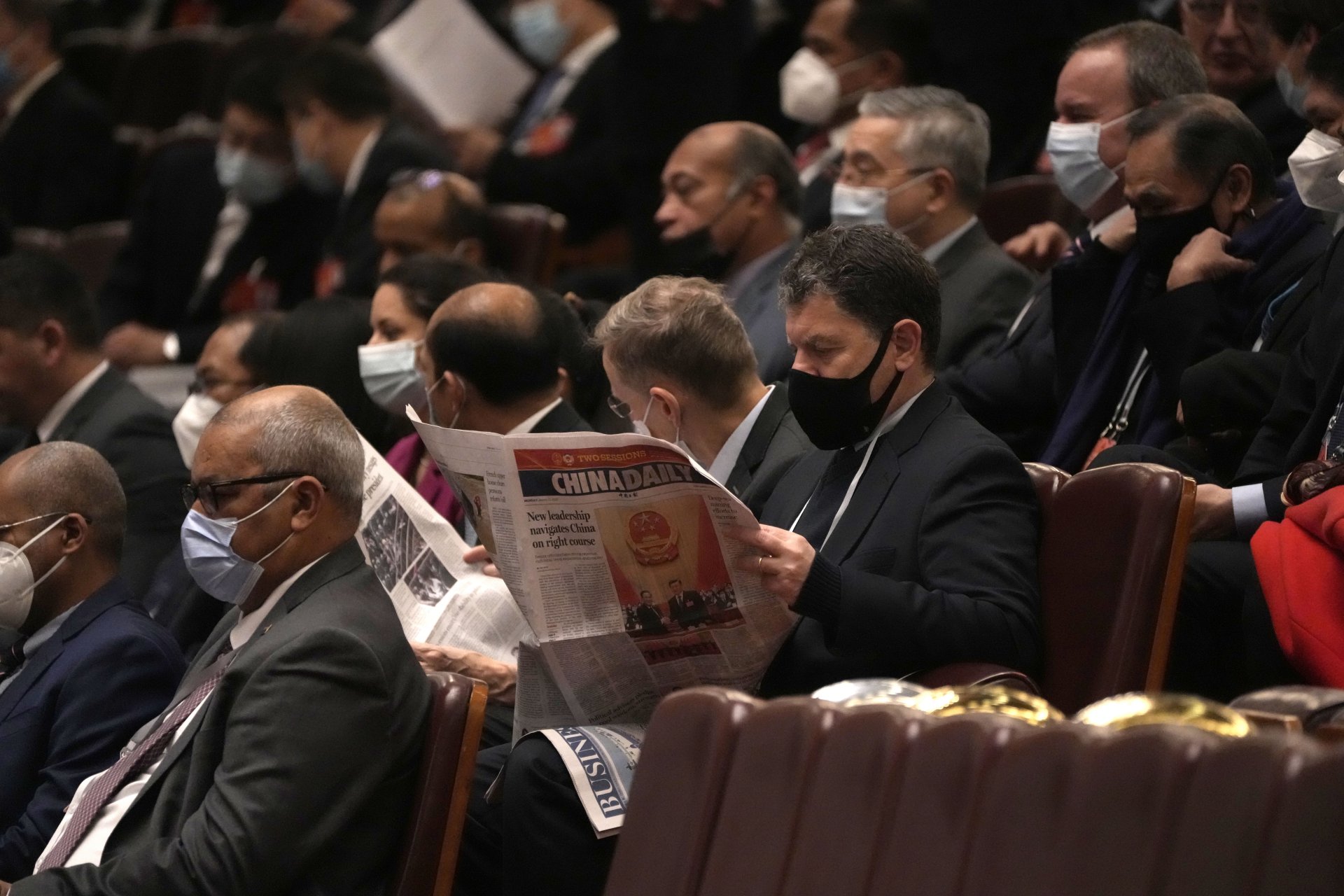 Чуждестранен дипломат чете вестник преди церемонията по закриването на Общокитайското събрание на народните представители в Голямата зала на народа в Пекин